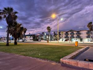 a park with palm trees and a street light at Heritage Resort Shark Bay in Denham