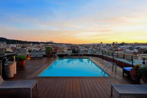 a swimming pool on the roof of a building at Hotel 1898 in Barcelona