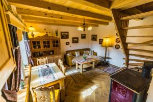 a living room with a couch and a table at Azyl nad Nidą in Rębów