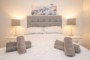 a bedroom with a large white bed with two lamps at Beautiful Victorian Apartment in Clacton-on-Sea