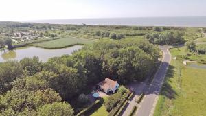 an aerial view of a house next to a river at Charmant vakantiehuis op unieke locatie in Groede +19 photos