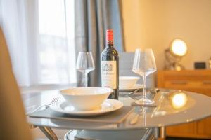 a bottle of wine sitting on a table with two glasses at Beautiful Victorian Apartment in Clacton-on-Sea +12 photos