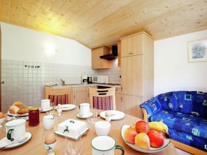 a kitchen with a table with a bowl of fruit on it at Charming Holiday Home in H ttau with Barbecue in Hüttau