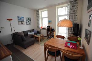 a living room with a table and a couch at Fürstenhof - Ferienwohnung 104 in Sassnitz