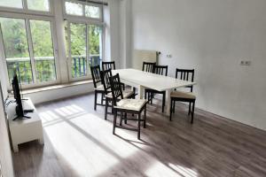 a dining room with a white table and chairs at Work & Stay Apartments in Stolberg in Stolberg