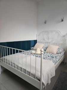 a bedroom with a white bed with a white rail at Apartamenty Wisełka in Wisełka +101 photos