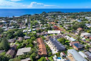 an aerial view of a suburb with a sign that reads our resort at Stylish 4BR Retreat with Water Views in Port Macquarie