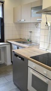 a kitchen with a sink and a stove top oven at Maye Oberhausen City Deluxe 3 in Oberhausen