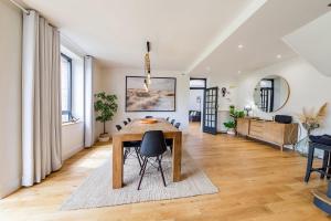 a dining room with a table and chairs at CLOS HILY - Maison d'exception à Dinard - 10 pers in Dinard