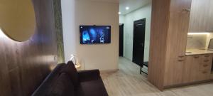 a living room with a tv hanging on the wall at EVA apartment in Vilnius +13 photos