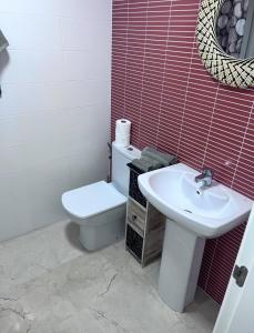 a bathroom with a toilet and a sink at Apartamento Saul in Beniarbeig