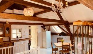 a kitchen with wooden ceilings and a table with chairs at Vakantie appartement Goedereede let op de badkamer moet met andere gasten gedeeld worden in Goedereede +14 photos