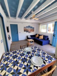 a living room with a table and a blue couch at Son de Mar by Concept in Denia