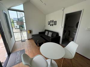 a living room with a white table and chairs at Mayuree-Homestay in Kranuan