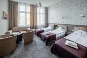 Posteľ alebo postele v izbe v ubytovaní Hotel Maximum