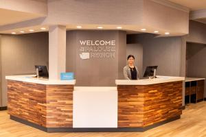 a man standing at a welcome counter in a lobby at Hampton Inn Pullman in Pullman