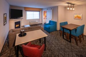a living room with a table and chairs and a dining room at Hampton Inn Pullman in Pullman