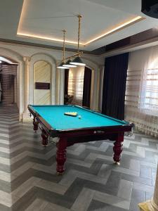 a pool table in a living room with at STATUS in Shymkent