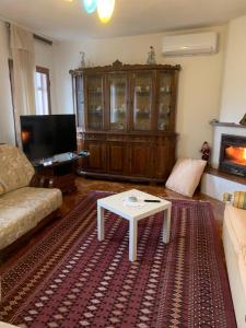 a living room with a couch and a coffee table at Guesthouse Villa Rosa Berat in Berat