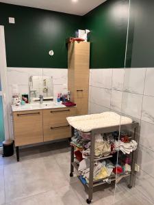 a bathroom with a sink and a table in it at Maison à proximité du circuit 24h in Saint-Gervais en-Belin +5 photos