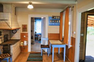 a kitchen with a table and chairs in a room at Dom na wsi u Kasi Hajnówka NA WYŁĄCZNOŚĆ 