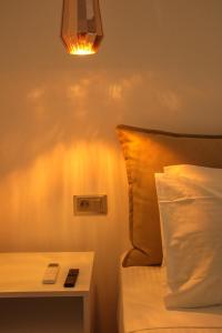 a bedroom with a bed and a nightstand with a lamp at POLYMNIA III LUXURY APARTMENT ARGOSTOLI in Argostoli +2 photos
