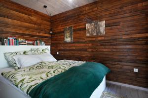 a bedroom with wooden walls and a bed in it at MARGARETT - Cozy House Kłodzko Jaszkowa Dln. in Kłodzko