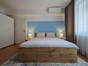 a bedroom with a large wooden bed with two lamps at Peaceful Victory Square Home in Timişoara