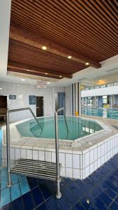 a large swimming pool in a building at Mantur Jerusalem Mountains by Selina in Maale Hachamisha