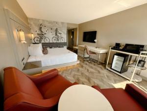 a hotel room with a bed and a desk at Coast Victoria Hotel & Marina by APA in Victoria