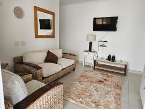 a living room with a couch and a tv at Li-Bru Self Catering Accommodation in Windhoek