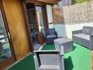 a patio with chairs and a table and a door at Cosy Old farmhouse in Schiltigheim