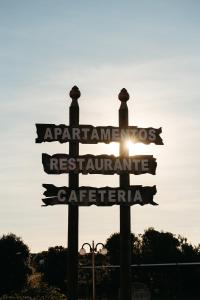 a street sign with the sun in the background at Apartamentos Ancoradoiro in Lariño
