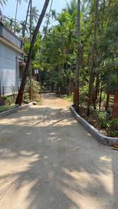 a road with trees on the side of a house at Sonchafa Stays in Nagaon