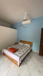 a bedroom with a bed in a blue room at Sonchafa Stays in Nagaon