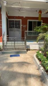 a house with benches in front of a building at Sonchafa Stays in Nagaon