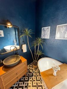 a bathroom with a sink and a tub and a mirror at Rhea Alaçatı Boutique Hotel in Alacati