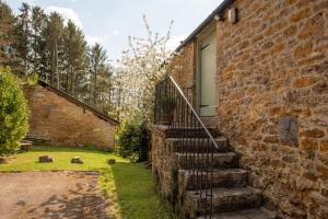 a brick house with stairs leading to a door at The Granary in Yeovil