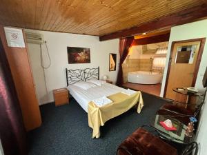ein Schlafzimmer mit einem Bett und einer Badewanne. in der Unterkunft Bucharest West Motel in Domneşti