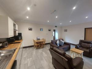 a living room with a couch and a table at Padley Farm in Bradfield