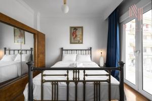 a bedroom with two beds and a window at Rocco, Nilie Hospitality MGMT in Thessaloniki