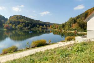 a view of a river with a boat on it at Hotel Garni Grottental in Meßstetten