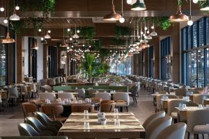 een restaurant met tafels, stoelen en ramen bij Swandor Hotels & Resorts - Kemer in Kemer