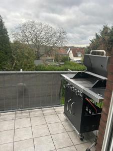 an outdoor kitchen with a stove on a balcony at Crazy Home in Hückelhoven