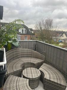 a patio with two wicker seats on a balcony at Crazy Home in Hückelhoven