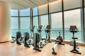 a gym with a row of treadmills and exercise bikes at Na Lotus Hotel, a Luxury Collection Hotel, Nanning in Nanning