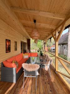 an outdoor living room with a couch and a table at Love Shack in Balatonudvari