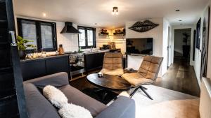 a kitchen and a living room with a couch and a table at Houseboat-Amsterdam in Amsterdam