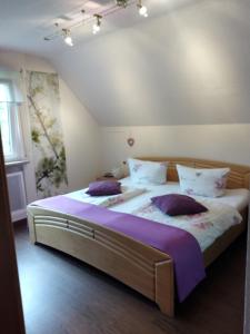 a bedroom with two beds with purple pillows at Ferienwohnung Rockenbach in Pünderich