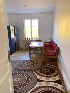 a dining room with a table and red chairs at Lägenhet/Apartment Krylbo, Avesta Sweden in Avesta